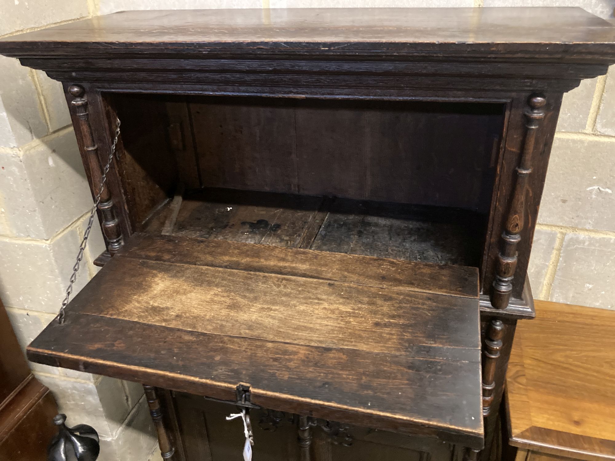 A 17th century style oak cupboard, width 100cm depth 42cm height 140cm